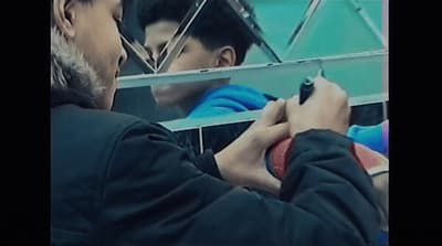 a man writing on a piece of paper