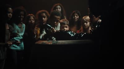 a group of people standing around a table