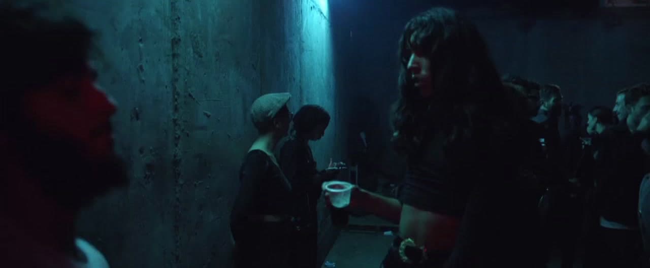 a group of people standing in a dark room
