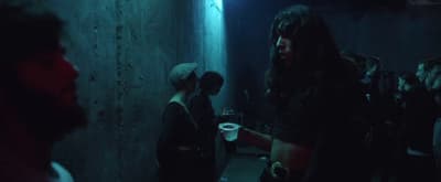 a group of people standing in a dark room