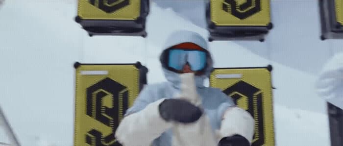 a person in a ski suit pointing at something