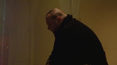 a man standing in a room with a remote in his hand