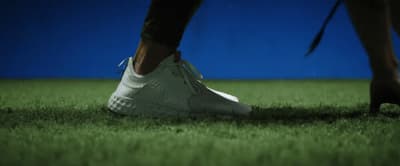 a close up of a person's feet in grass