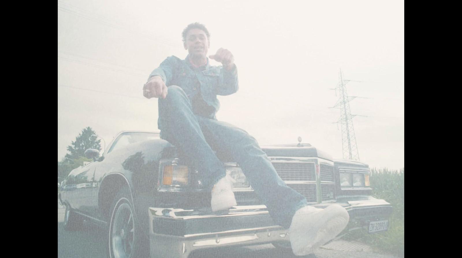 a man sitting on the back of a truck