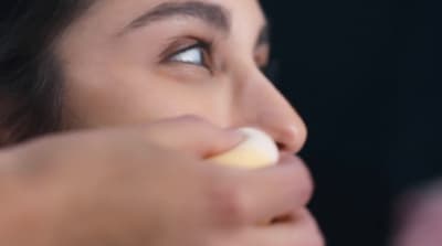 a woman is putting something in her mouth