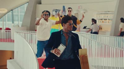 a group of men walking down a hallway next to each other