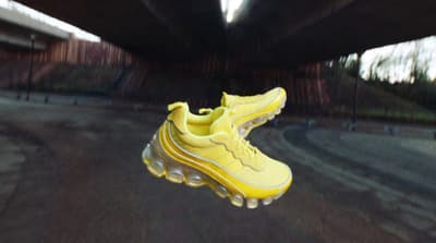 a pair of yellow shoes hanging from a ceiling