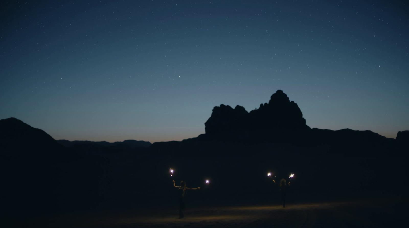 a couple of lights that are standing in the dirt
