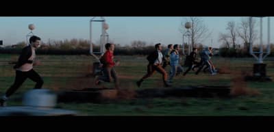 a group of people running across a field