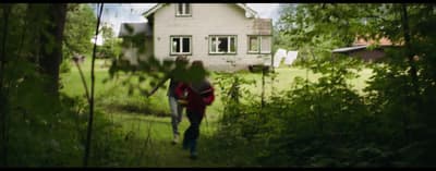 a couple of people that are walking in the grass