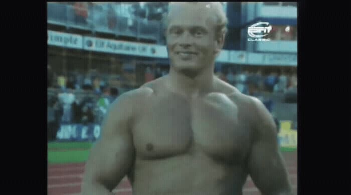 a man without a shirt standing on a baseball field