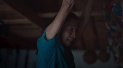 a woman is holding a remote in her hand