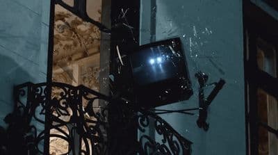 a tv that is on the side of a building