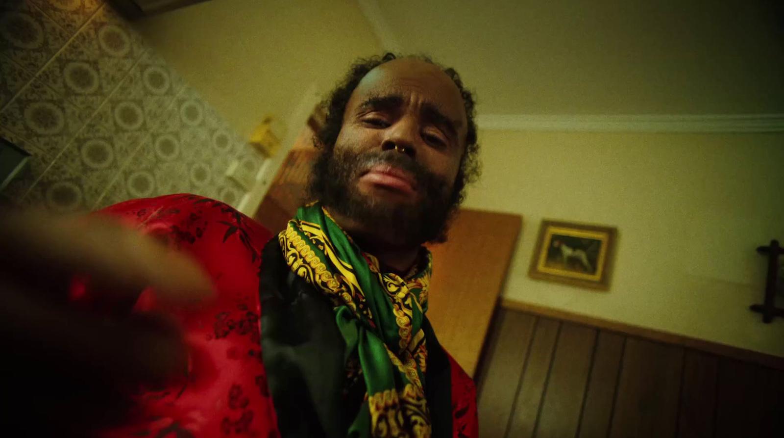 a man with a beard wearing a red and yellow shirt