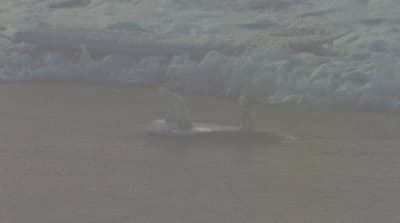 a person riding a surfboard on a body of water