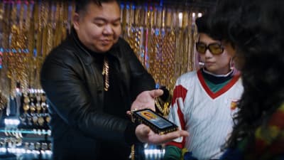 a man holding a cell phone next to a woman