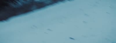 a blurry photo of a snowboarder going down a hill