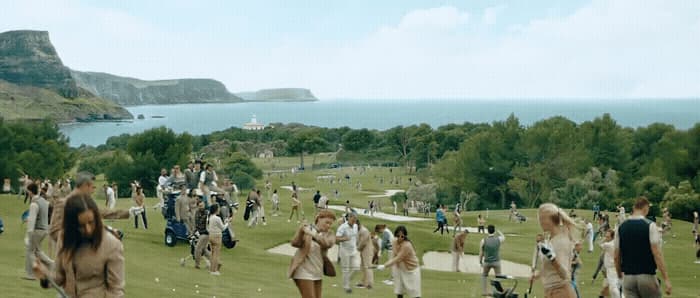 a large group of people walking on a grassy field