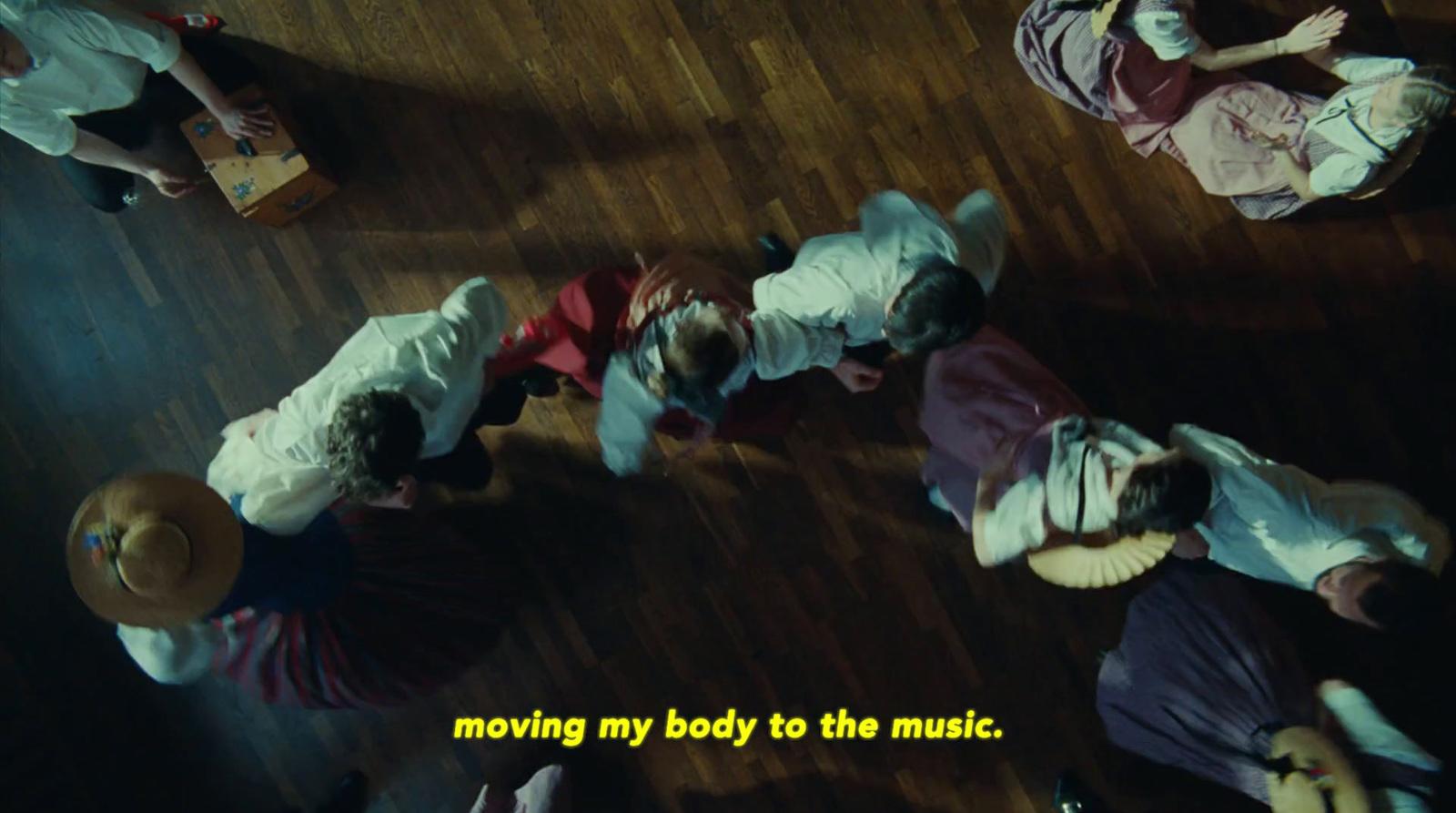 a group of people standing on top of a wooden floor