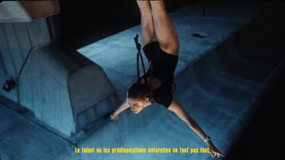a woman hanging upside down on a rope