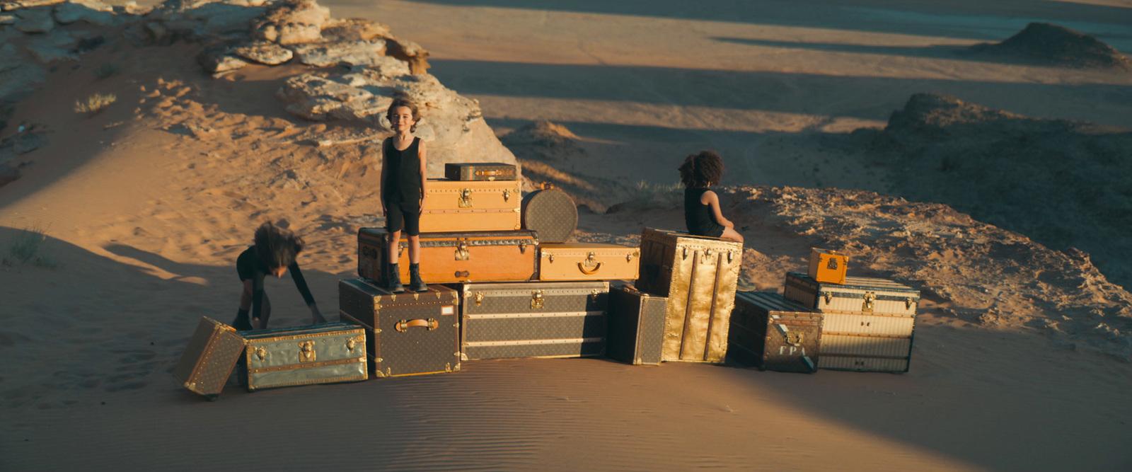 a group of people standing on top of a pile of luggage