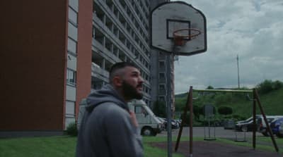 a man standing in front of a basketball hoop