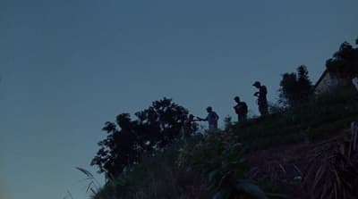 a group of people standing on top of a hill