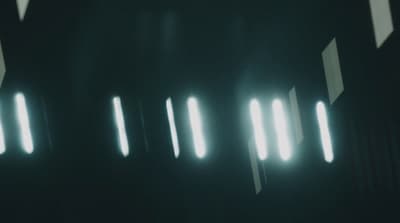 a black and white photo of some lights in the dark