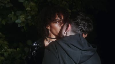a man and a woman kissing in the dark