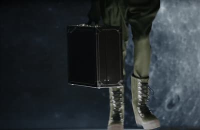 a person holding a piece of luggage in their hand