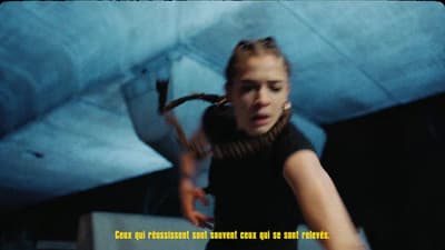 a woman in a black shirt is holding a skateboard