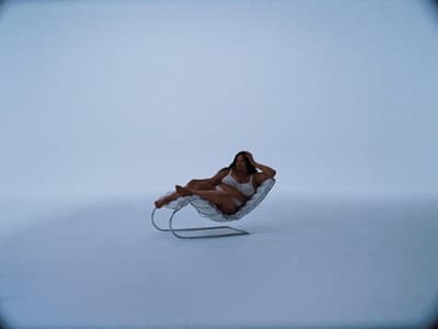 a woman laying on a chair in the snow