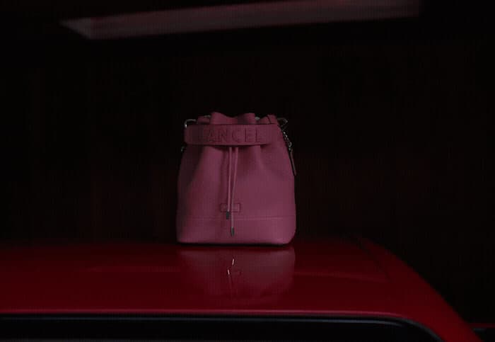 a pink purse sitting on top of a red car