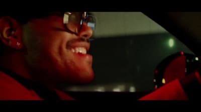 a man wearing glasses and a red shirt