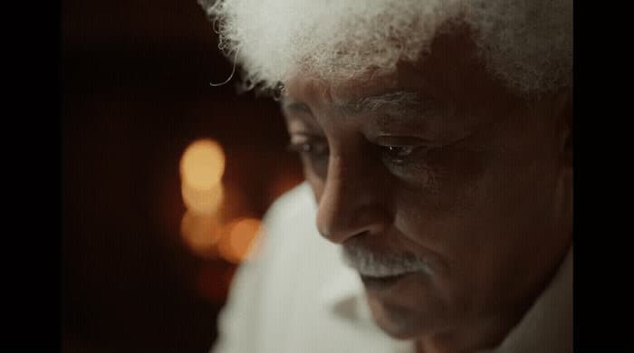 a close up of a person wearing a white shirt