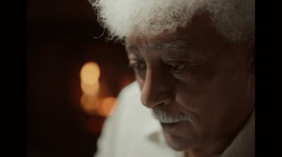 a close up of a person wearing a white shirt