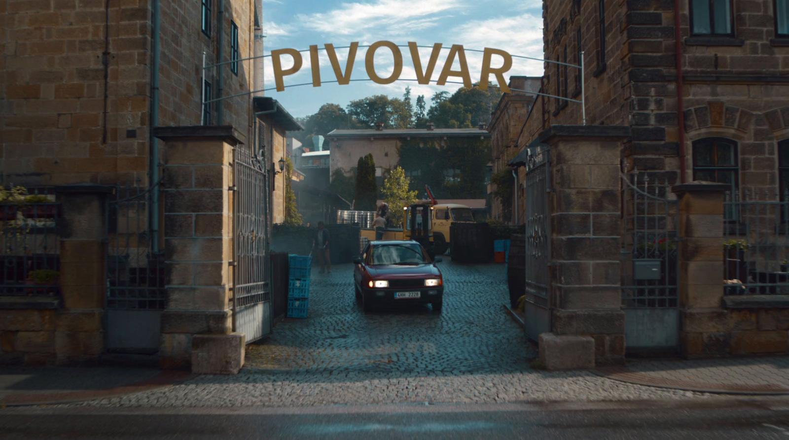 a car is parked in front of a brick building