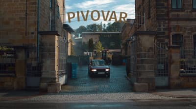 a car is parked in front of a brick building