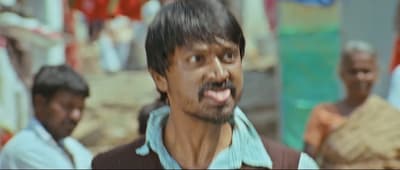 a man making a funny face while standing in front of other men