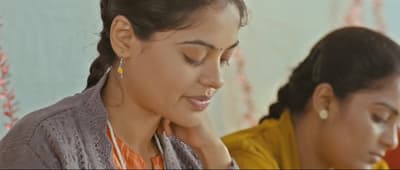 a couple of women sitting next to each other