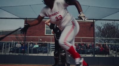 a baseball player holding a bat on top of a field