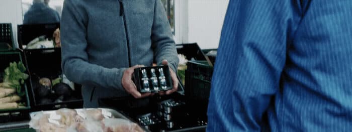 a man holding a box of food in his hands