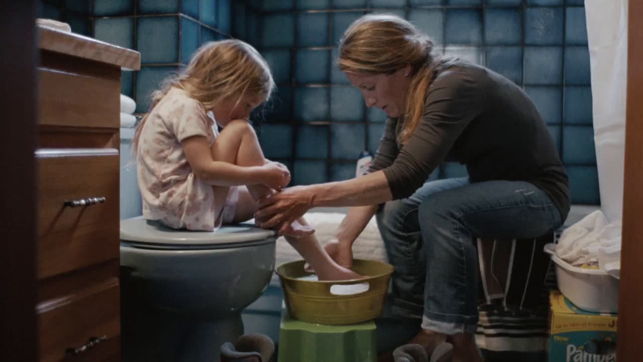 a woman and a little girl sitting on a toilet