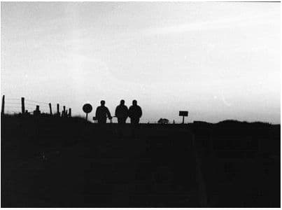 a group of people standing on top of a hill