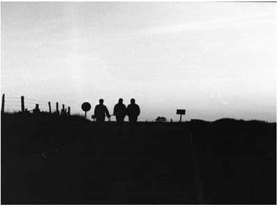 a group of people standing on top of a hill