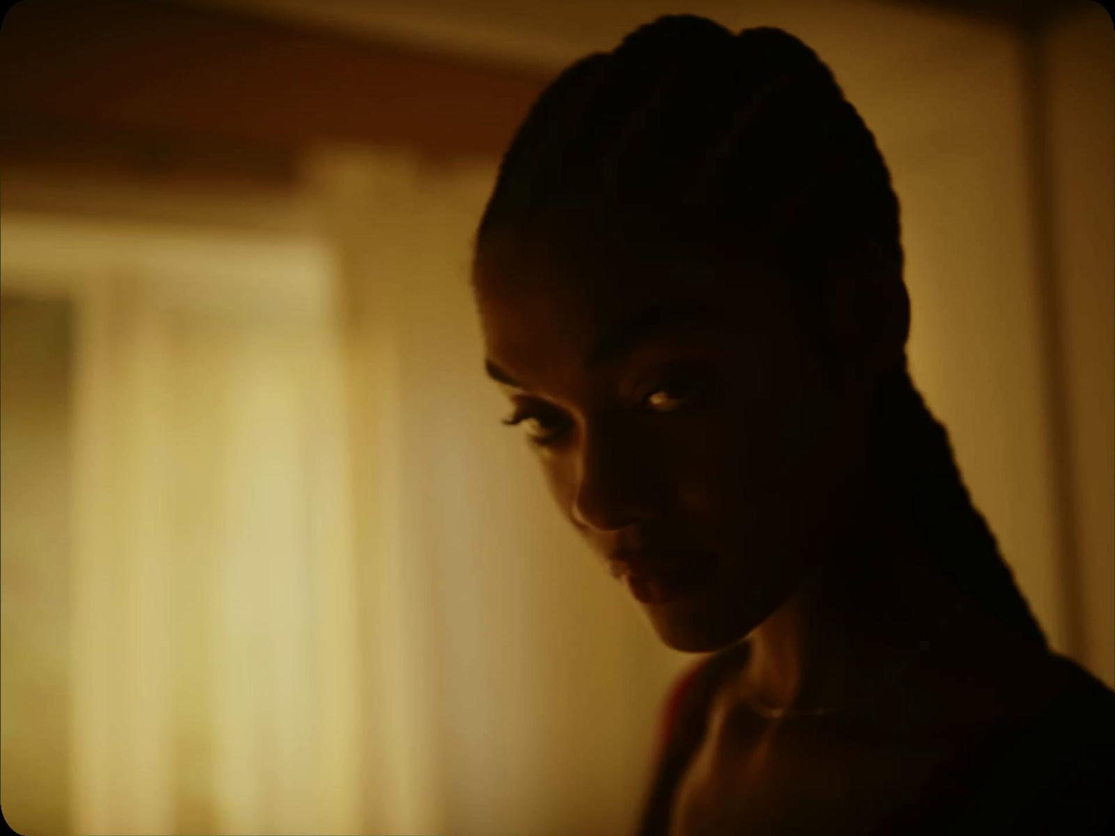 a woman with braids in a dark room