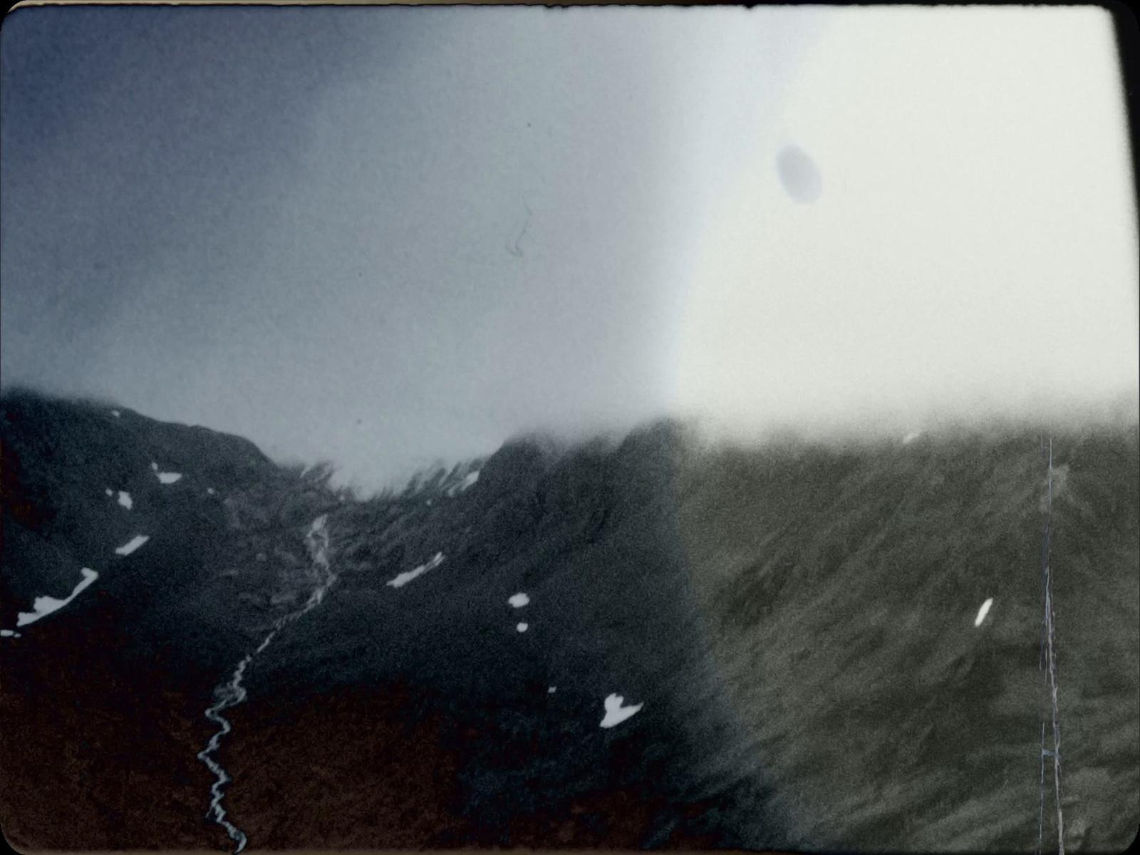 a black and white photo of a mountain