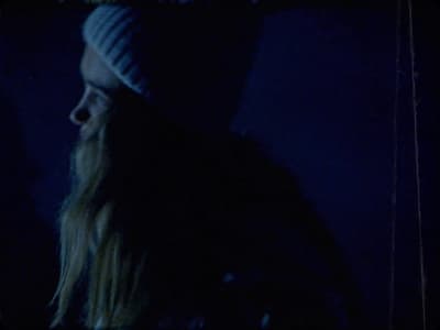 a man with long hair wearing a beanie