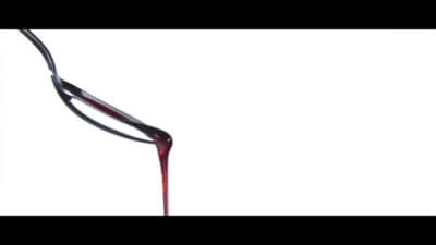 a red liquid pouring out of a wine glass