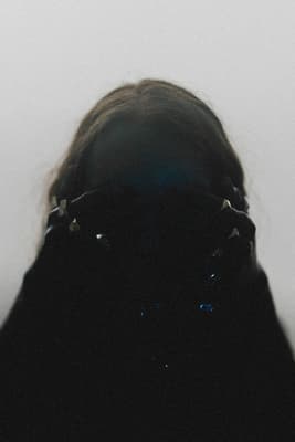 a woman's head is shown in the dark